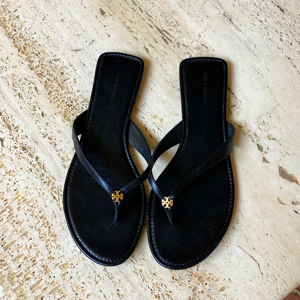 Tory Burch black leather flip-flops.